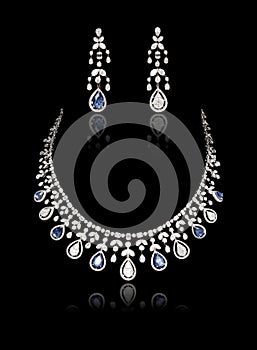 Close up of diamond necklace set on with diamond earring isolated on black