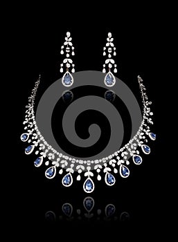 Close up of diamond necklace set on with diamond earring isolated on black
