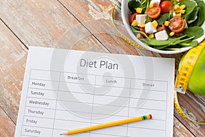 Close up of diet plan and food on table