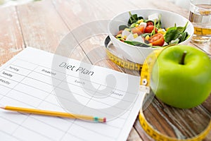 Close up of diet plan and food on table