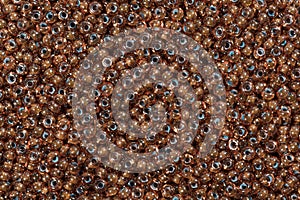 Different brown seed beads background.