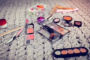 Close up of different cosmetics items lying on the floor