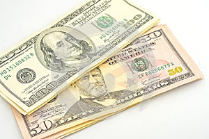 Close up of different dollar bills. Isolated on a white background. 100 and 50 dollar bundles up close on a white