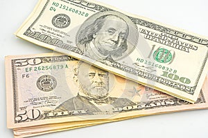 Close up of different dollar bills. Isolated on a white background. 100 and 50 dollar bundles up close on a white