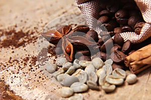 Close-up different types of coffee beans in a bag, green coffee, sticks of cinnamon and anise star, macro, set