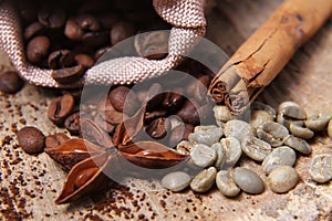 Close-up different types of coffee beans in a bag, green coffee, sticks of cinnamon and anise star, macro, set