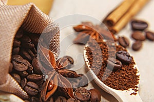 Close-up different types of coffee beans on wooden spoon, sticks of cinnamon and anise star, macro, set