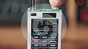 Close-up Digital LCD Screen of Modern Handy Radio with Scanning FM Frequency