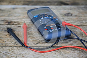 Close-up of digital multimeter on wooden background, Worker used electronic tools for checked circuit