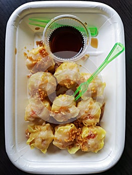 Close up Dim Sum ,Chinese food steamed dumpling and sauce on plate isolate on white background.Top view dumpling on white.