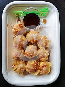 Close up Dim Sum ,Chinese food steamed dumpling and sauce on plate isolate on white background.Top view dumpling on white.