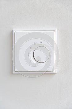 Close up of dimmer switch against a white wall