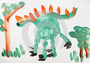 Close up. Dinosaur, Jurassic Park. Drawing with finger paints, children`s palm.Creative activities with children 3-4 years old on