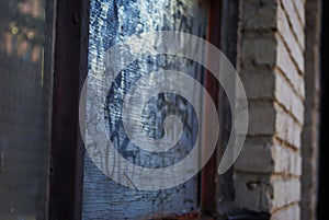 Close up of a dirty broken boarded up window sill on an abandoned building