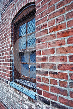 Close up of a dirty broken boarded up window sill on an abandoned building