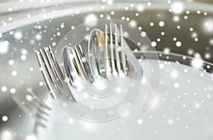 Close up of dirty dishes washing in kitchen sink