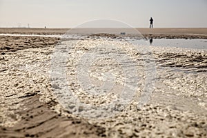 Close-up of dirty foam on the beach