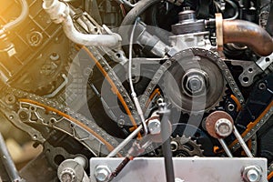 Close-up on a disassembled engine with a view of the gas distribution mechanism, chain, gears and tensioners during repair and