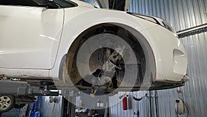 Close-up of a disassembled wheel with a brake pad in a car at a service station.