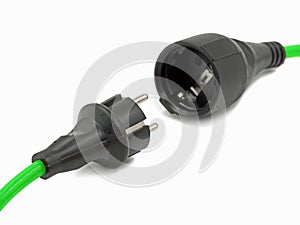 Close up, disconnected green electrical power extension cable with EU plug, green energy