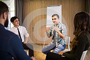 Close-up on discussion. Close-up of people communicating while sitting in circle and gesturing