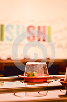 Close up of a dish on the conveyor belt sushi in a Kaiten Sushi