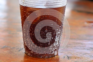 Close-up of disposable plastic drinking glasses with ice and soft drinks