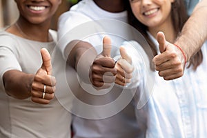 Close up diverse people showing thumbs up