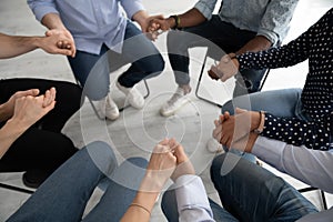 Close up diverse people sitting in circle at psychological session