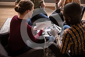 Close up of diverse  Business meeting. Focus on hands and document being discussed photo