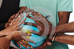 Close up of diverse teenagers hands delicately exploring a globe, capturing the essence of curiosity and photo