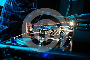 Close up of dj control panel playing party music on modern player in disco club photo