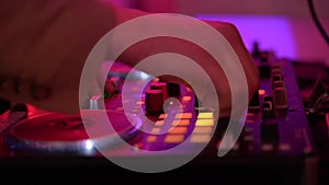 Close up of dj playing party music on modern cd usb player in disco club