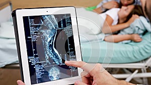 Close up doctor checking MRI results on tablet PC