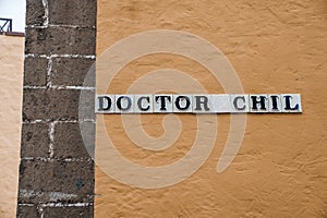 Close-up of doctor chil signboard on old wall of building in old town