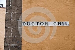 Close-up of doctor chil signboard on old wall of building in old town photo