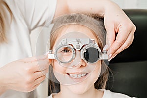 close up. doctor diagnoses little girl's vision and makes selection of lenses.