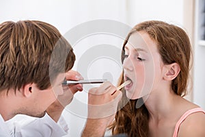 Close-up Of Doctor Examining Girl`s Throat