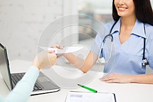 Close up of doctor giving prescription to patient