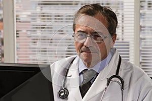Close up of doctor in office using computer, horizontal