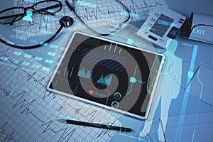 Close up of doctor`s desktop with pad, stethoscope and glowing online medicine hologram. Healthcare, future and technology concep