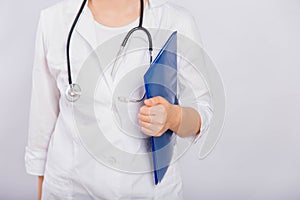 Close-up of a doctor`s hand holding a blue folder, a young woman in a white coat on a white background, copy space.