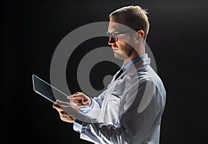 Close up of doctor or scientist with tablet pc