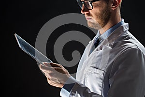 Close up of doctor or scientist with tablet pc