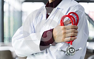 Close up doctor stood and Crossed Arms with a stethoscope at the hospital. He looked at the camera with copy space and blur back
