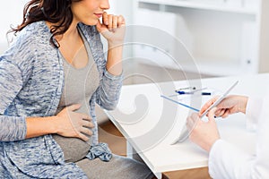 Close up of doctor with tablet and pregnant woman