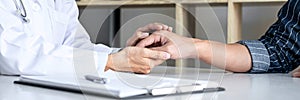 Close up of doctor touching patient hand for encouragement and empathy on the hospital, cheering and support patient, Bad news,