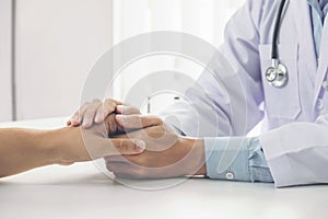 Close up of doctor touching patient hand for encouragement and empathy on the hospital, cheering and support patient, Bad news, me