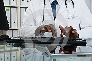 Close-up Of Doctor Typing On Keyboard