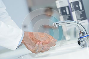 Close up doctor washing hands